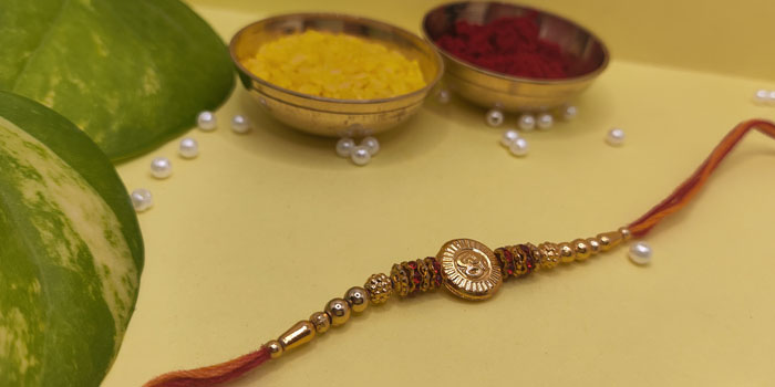 Divine Rakhi with Om Design in the Centre and Roli - Chawal