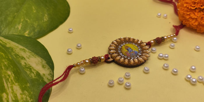 Sunflower Shaped Rakhi with Lord Rama in the Centre and Roli - Chawal